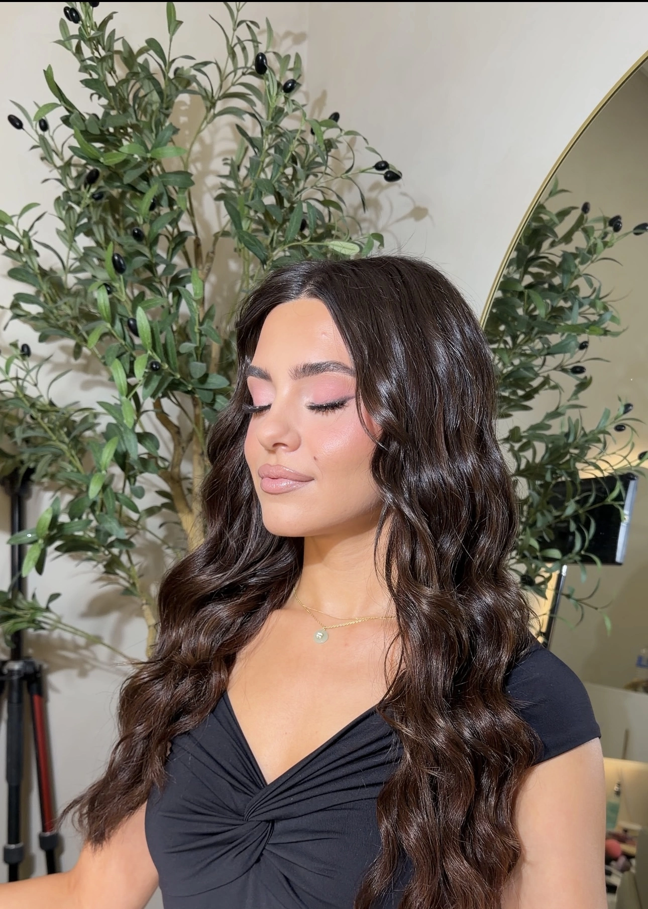 Long glossy dark brunette hair styled in soft beach waves